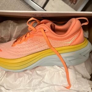 Hoka One One W Bondi 8 in coral peach colorway.